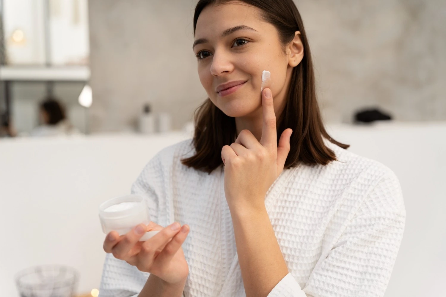 Woman applying face cream moisturizing step for daily skin comfort and softness - Zicail Beauty - Zicail Beauty Woman applying face cream moisturizing step for daily skin comfort and softness - Face Care Products - Face Care Products